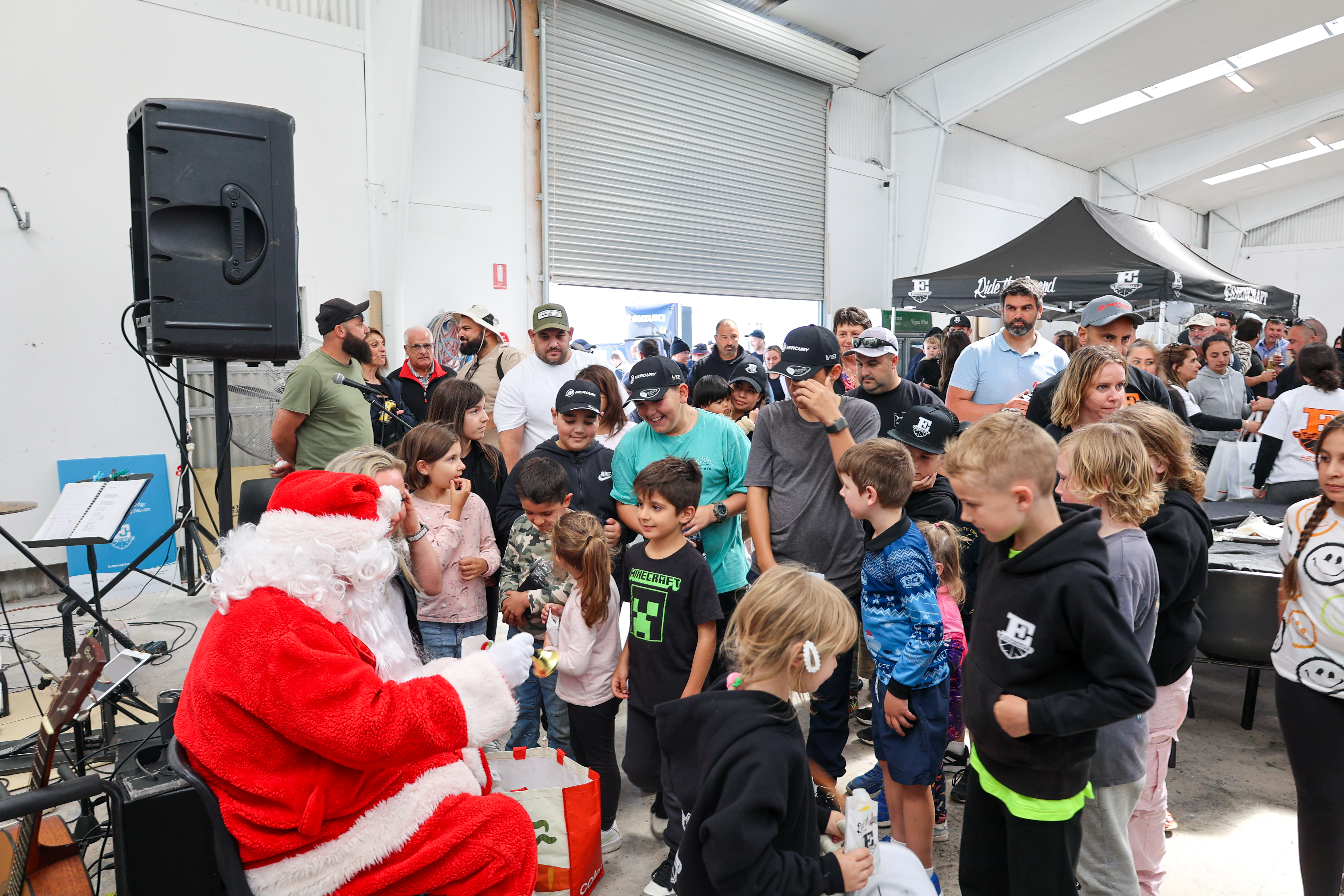 Santa handing out gifts to kids at Edencraft Family Day